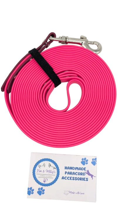 Pink dog leash with a metal clip on a white background